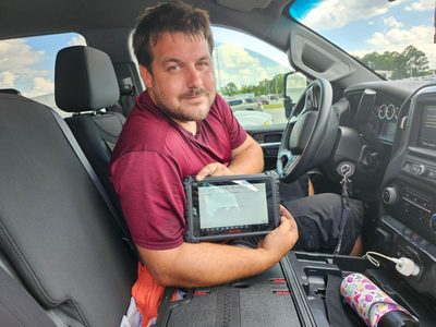 Mission Auto Glass technician processing an insurance claim on tablet