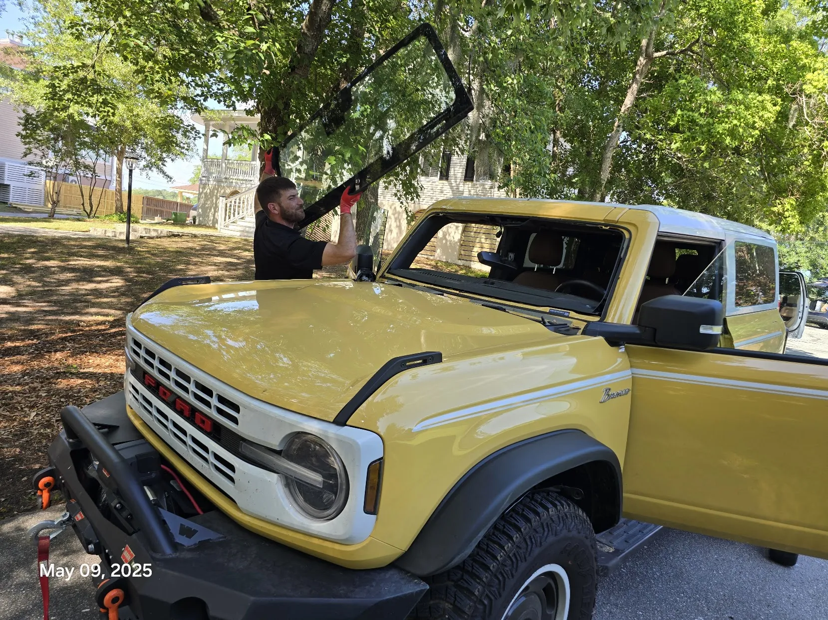 Mission Auto Glass technician performing mobile windshield replacement in Charleston SC neighborhood
