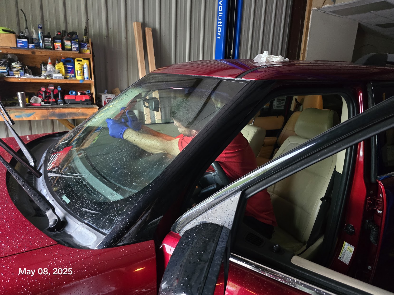 Windshield repair in progress on a red vehicle — the type of damage Hanahan commuters encounter on I-26